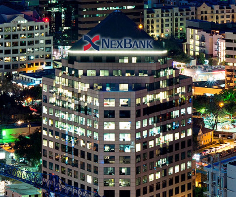 night time skyline view of NexBank building in downtown Dallas Texas